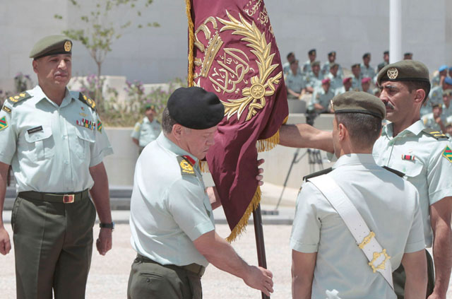 His Majesty King Abdullah, the Supreme Commander of the Jordan Armed Forces-Arab Army, presents the Supreme Commander’s Colours to an army battalion on Monday (Petra photo)  
